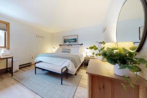a bedroom with a bed and a large window at White Mountain Chalet in Bartlett