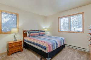 a bedroom with a bed and two windows at 513 Cache in Jackson