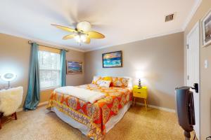 a bedroom with a bed and a ceiling fan at O'Hara Haven in Dauphin Island