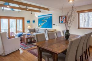 a living room with a wooden table and chairs at Harbor Village House in Rockport
