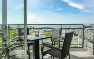 einen Tisch und Stühle auf einem Balkon mit Meerblick in der Unterkunft 1 Bedroom Stunning Apartment In Tranekr in Lohals
