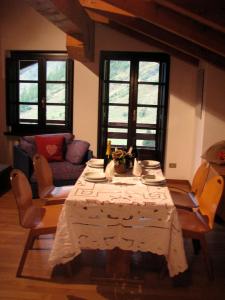 a living room with a table and a couch at Il Piccolo Residence in Gressoney-la-Trinité