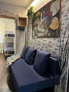 niebieska kanapa w pokoju ze ścianą w obiekcie Coqueto apartamento muy céntrico w Madrycie