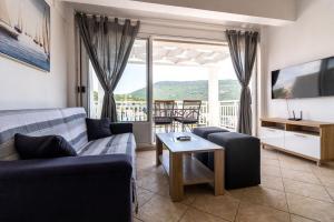 a living room with a couch and a table at Villa Tiha luka in Neum
