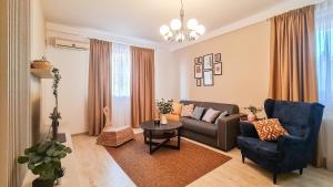 a living room with a couch and a table at Orange Onix Apartaments in Bucharest