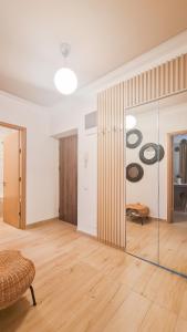 a living room with a glass partition with records on the wall at Orange Onix Apartaments in Bucharest