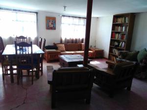 a living room with a couch and a table and chairs at Beautiful Rustic Cottage Adobe, Rancho El Payasito in Cuauhtémoc