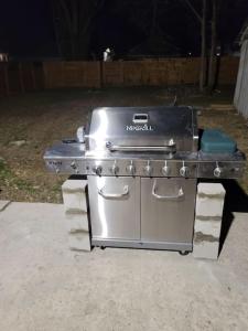 a stainless steel stove in a backyard at night at Luxurious 6 bedroom villa near downtown in San Antonio