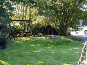 a yard with a swing set in the grass at 8 person holiday home in Gilleleje in Gilleleje