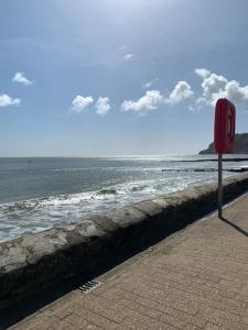 a red stop sign on the side of a beach at 1 Bed Apartment - Sea view in Shanklin