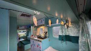 a small room with a vanity and lights in an rv at Ir por ai Arrábida in Azeitao
