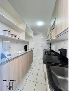 a kitchen with a sink and a counter top at MSHome - Apartamento Térreo com Varanda e Mobiliado in João Pessoa