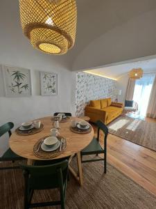 a living room with a table and a yellow couch at Madre de Deus, 5 - Terrace in Évora