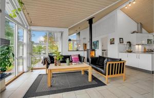 a living room with a couch and a table at Stunning Home In Fars With Sauna in Hvalpsund