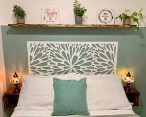 a bedroom with a white bed with two lamps at Lar Expresso 2222 in Salvador +47 photos