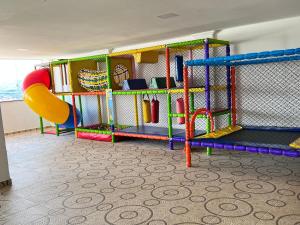 a play room with a slide and a playground at Mirante Eventos & Hospedagem in Cachoeira Paulista