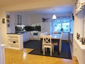 a kitchen with a dining room table and chairs at Säfsen Stay in Ludvika