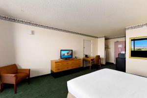 a hotel room with a bed and a television at Studio 6 Suites Lake Havasu City AZ in Lake Havasu City