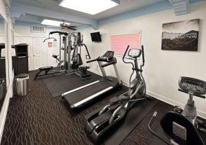a gym with two exercise bikes and a treadmill at Suites Dallas TX Downtown in Dallas