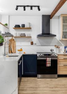 a kitchen with a black stove and a sink at The Maple House in Seattle