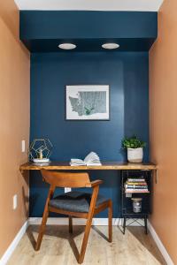 a desk in a room with a blue wall at The Maple House in Seattle