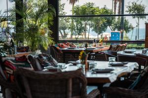 a restaurant with tables and chairs and a large window at ONLY ONE Suites & Residences in Antalya