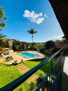 a view from the balcony of a house with a swimming pool at Hotel Chalés Gramado in Santa Bárbara do Rio Pardo