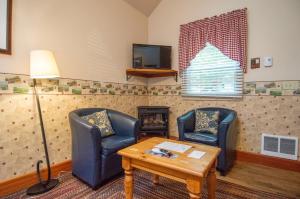 a living room with two chairs and a table at The Swan Hotel in Port Townsend