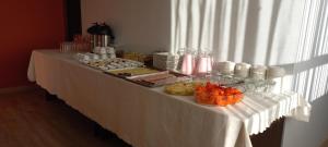 a long white table with food on it at Hotel CESARE in Uyuni +36 photos