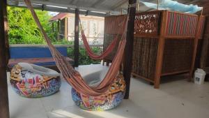 a couple of hammocks sitting on a porch at El Hamaquero Hostal EcoNativo in Isla Grande