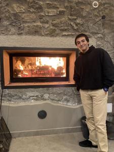 a man standing in front of a fireplace at Villa Paladini in Montefiascone