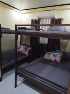 a group of bunk beds in a room at Jumong's Transient in Bantay