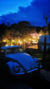 een blauwe auto geparkeerd op een parkeerplaats 's nachts bij Trailer Oasis in Lavras Novas