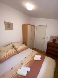 a bedroom with a bed with two towels on it at Apartments with parking space Sutivan, Brac - 2846 in Sutivan