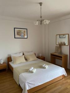a bedroom with a large bed with two towels on it at Apartments with parking space Sutivan, Brac - 2846 in Sutivan