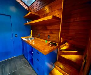 a bathroom with a sink and a wooden wall at Casa Alfeñique in Villa del Carbón