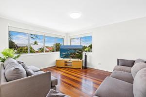 a living room with two couches and a tv at Ultimate Burleigh Beach House Family Retreat! - 5 BEDROOMS in Gold Coast