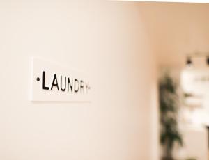 a sign on the door of a room with the word laundry at The Maple House in Seattle