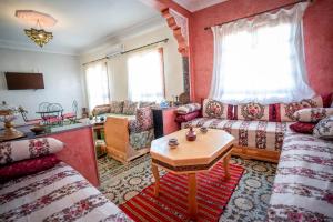 a living room with a couch and a table at Dar El Karam Fez in Fez