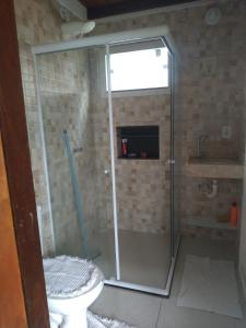 y baño con ducha, aseo y lavamanos. en Casa Guaiú, en Santa Cruz Cabrália
