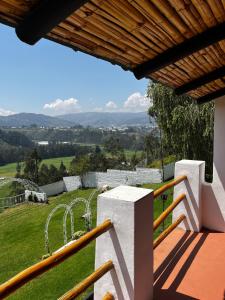 a view from the balcony of a house with a playground at Hostería El Troje Experience in Riobamba