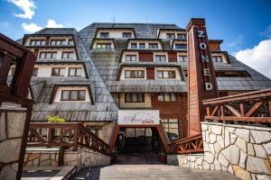 a building with a metal roof on a bridge at Velvet Studio Zoned Kopaonik in Kopaonik