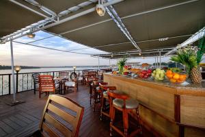 a bar on a cruise ship with tables and chairs at Nile Cruise 3 nights From Aswan to Luxor Every Friday, Monday and Wednesday with tours in Jazīrat al ‘Awwāmīyah