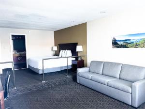 a hotel room with a bed and a couch at The Georgian Resort in Lake George