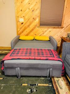 a bed sitting in a room with a couch at The Barn in Asheville