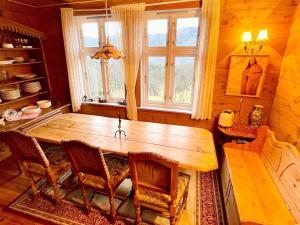 a dining room with a wooden table and chairs at 8 person holiday home in Åkra-By Traum in Åkra +20 photos