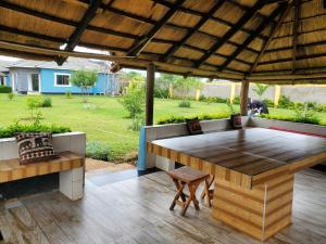 a patio with a large wooden table and chairs at Sweet Retreat in Lusaka