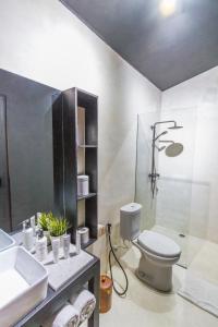 a bathroom with a toilet and a sink at Villa Lagoon - Elegant & Absolute BeachFront in Nusa Ceningan in Nusa Lembongan