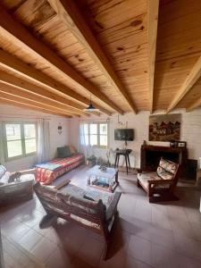a large living room with a couch and a fireplace at Casa Azul in Potrerillos