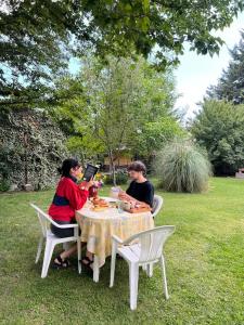 a group of people sitting at a table in the grass at Casa Azul in Potrerillos